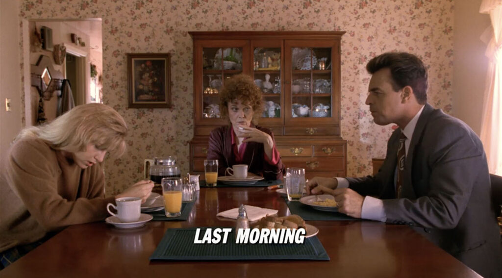 Three people sitting at a breakfast table