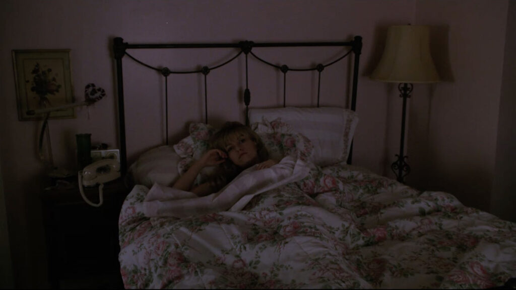 Laura Palmer laying in bed at night