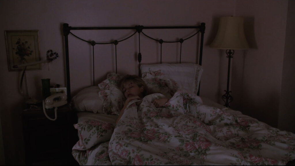 Laura Palmer sleeping in her bedroom.