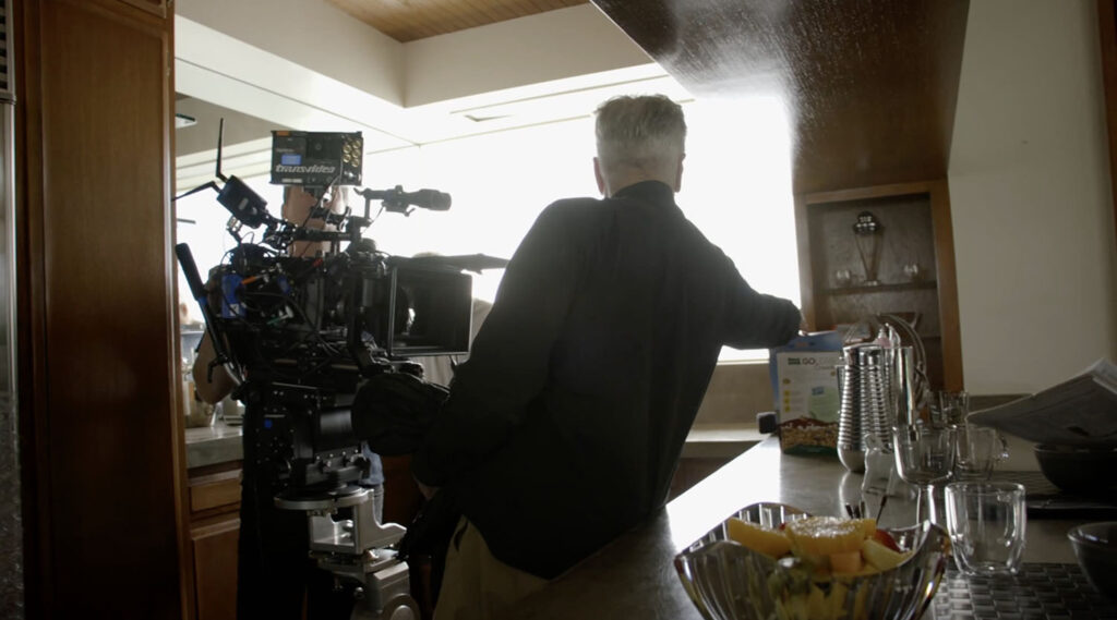 David Lynch reaching for box of cereal in the kitchen