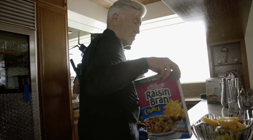 David Lynch holding a box of Raisin Bran Crunch