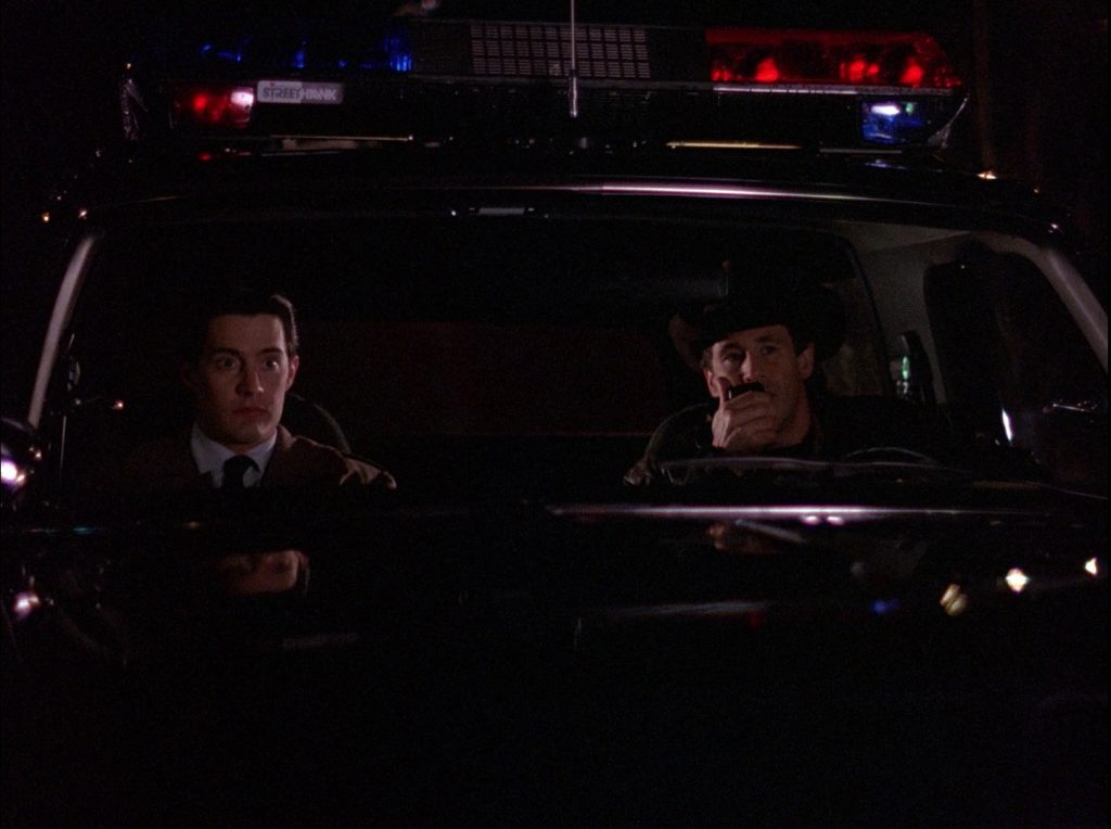 Agent Cooper and Sheriff Truman sitting in Ford Bronco
