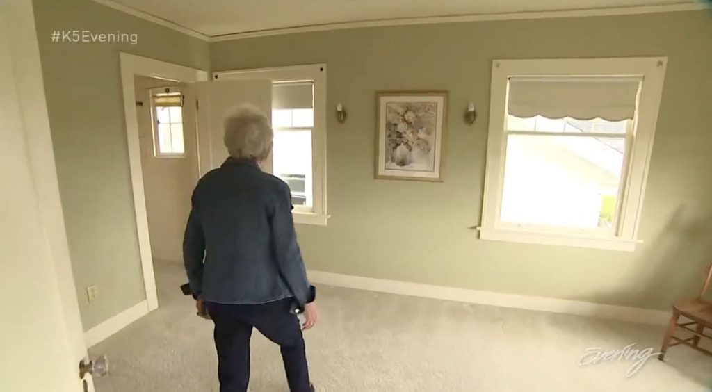 Person standing in an empty bedroom
