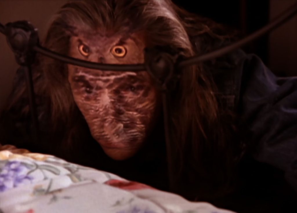 Killer BOB hiding at the end of Laura's bed with an owl image superimposed over his face