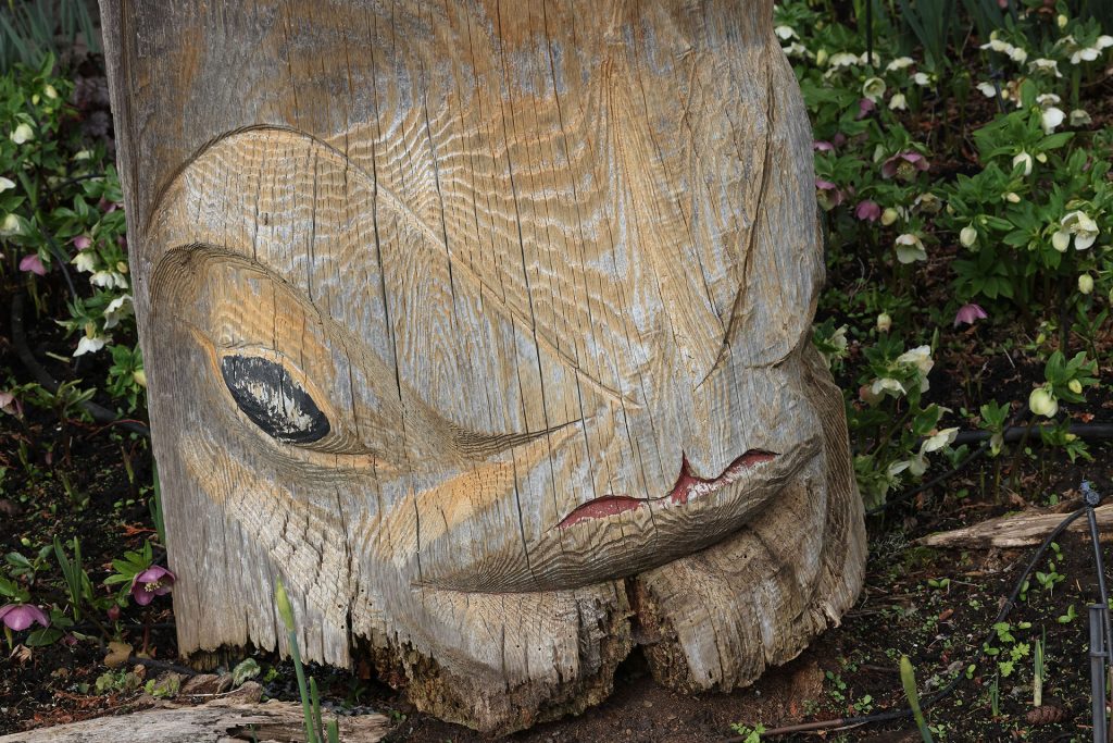 Carved wooden Sealion at the bottom of a story pole