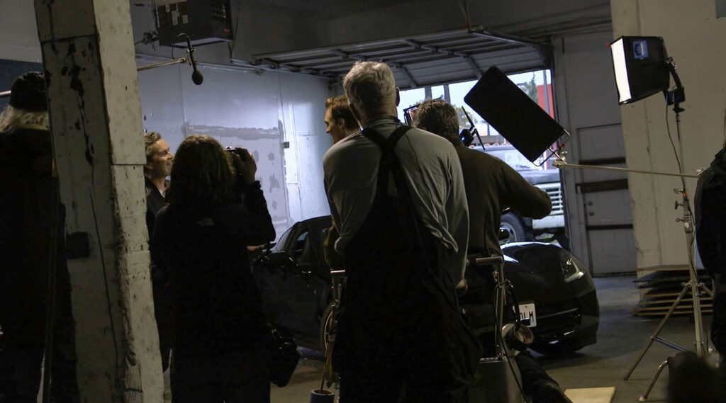 Film crew in a garage