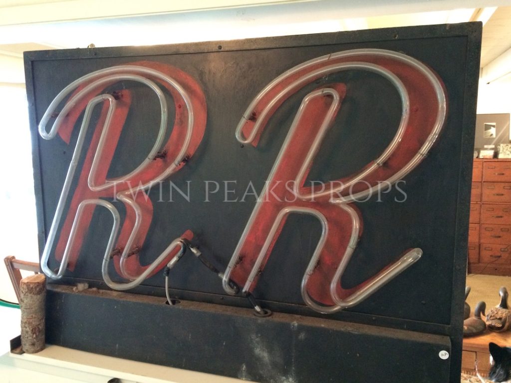 Black neon sign with red RR