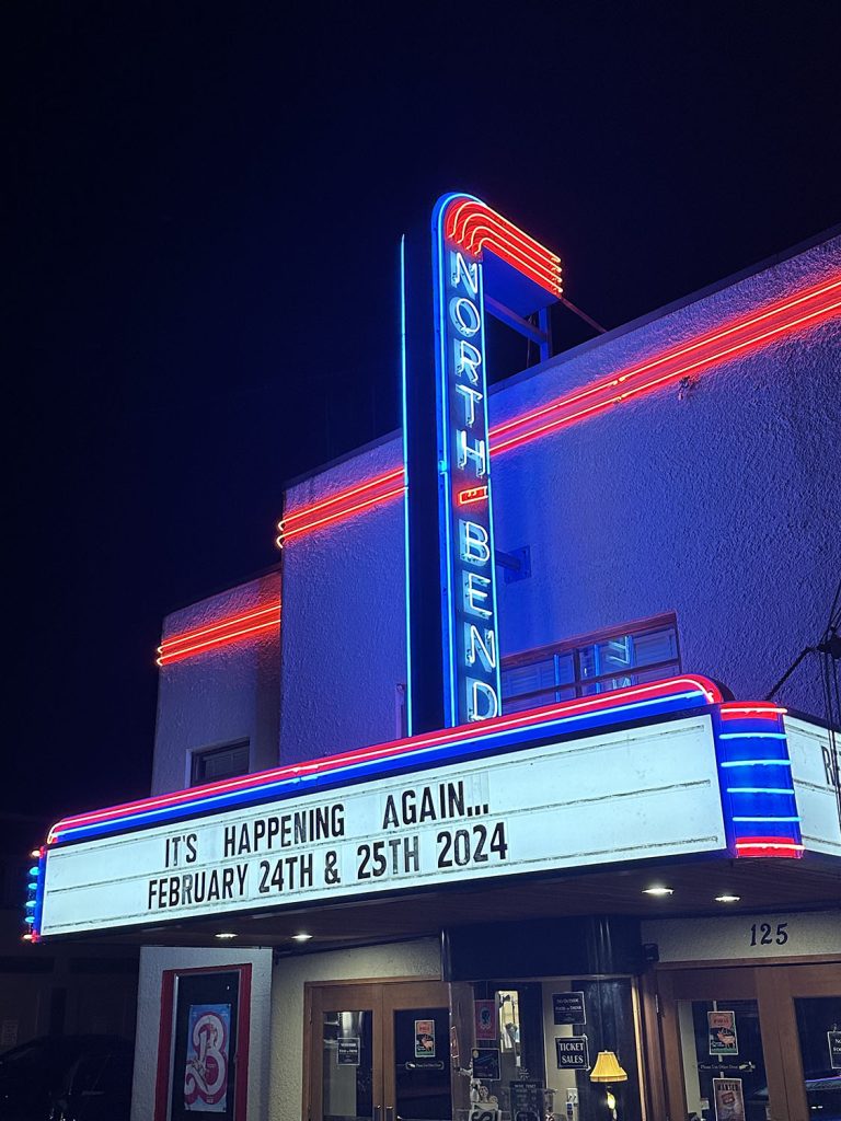 North Bend Theatre illuminated by neon with the marquee