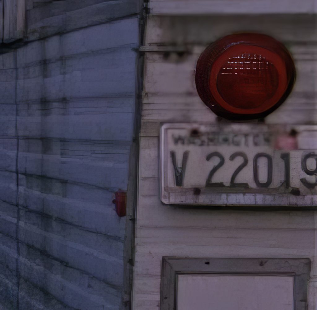 Corner of a trailer with a license plate and tail light