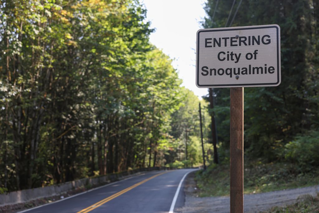 Entering City of Snoqualmie sign along two-lane road