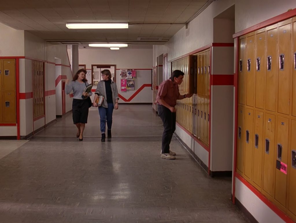 Dancing kid and two female students in the hall at Twin Peaks High School