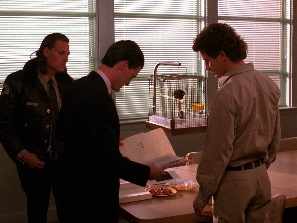 Deputy Hawk, Agent Cooper and Sheriff Truman next to Waldo the Myna Bird at the Twin Peaks Sheriff's Department