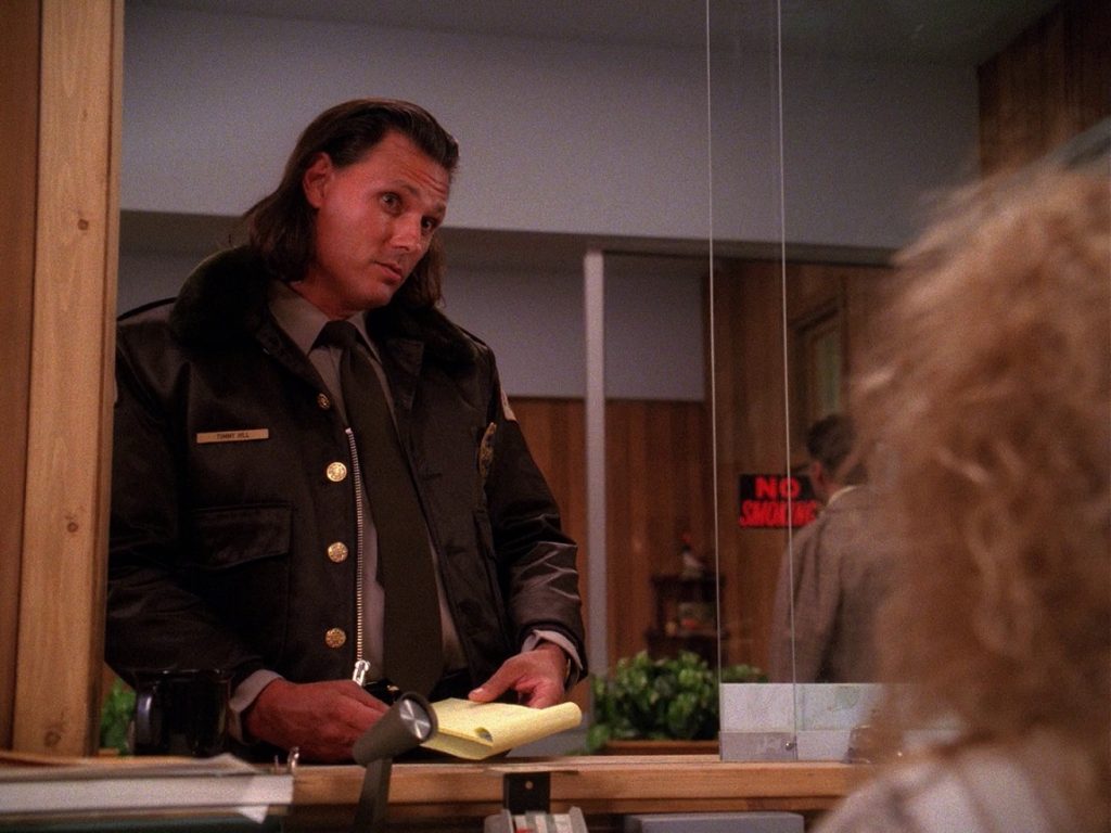 Deputy Hawk at Lucy Moran's reception desk in the Twin Peaks Sheriff's Department