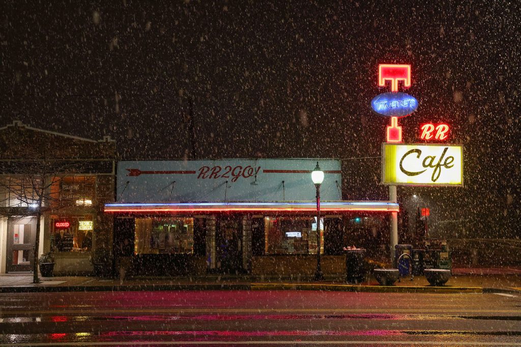 Twede's Cafe at night with snow falling