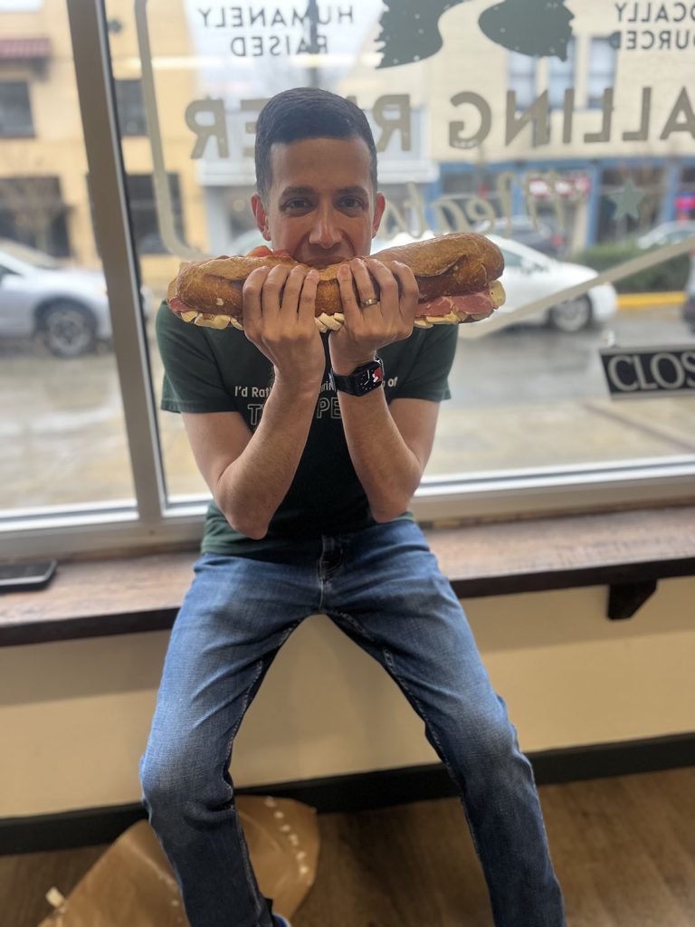 Aaron Cohen eating a best damn sandwich
