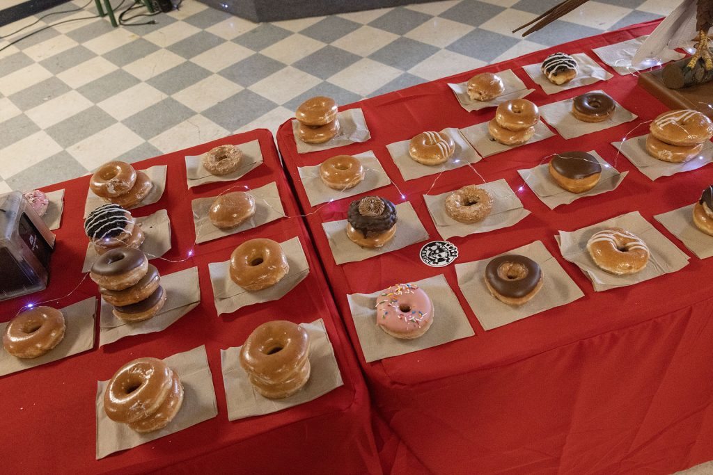 Doughnuts stacked on a red-skirted table