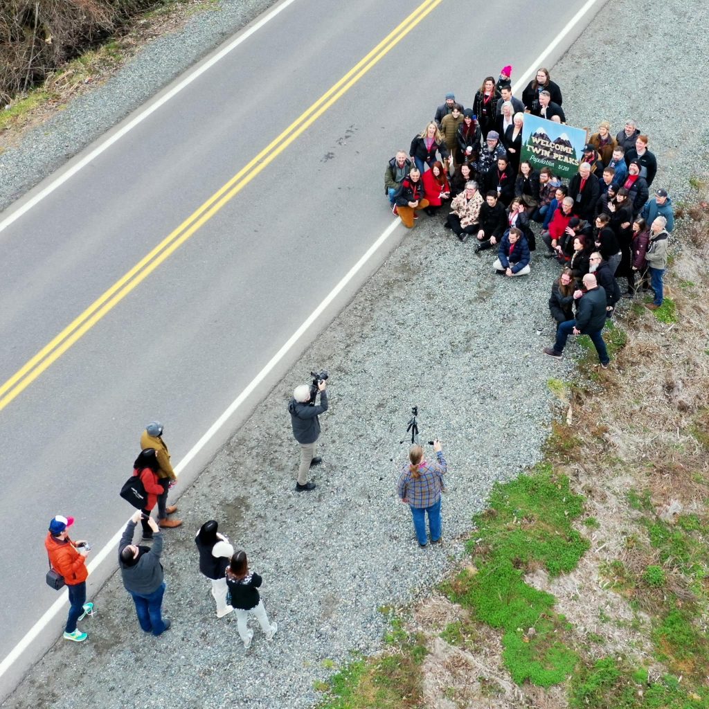 Aerial shot of people gathered by sign