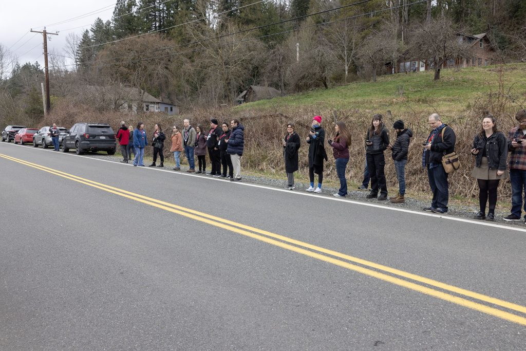 People lined up along the side of the road