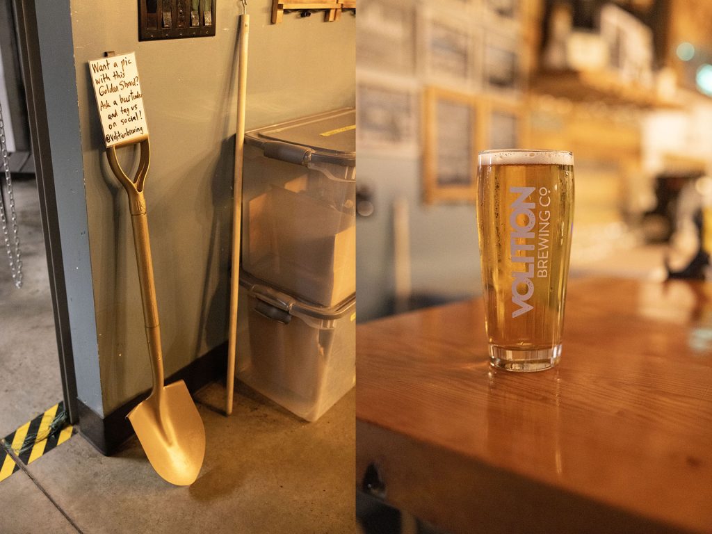 Golden Shovel leaning against a wall and a beer on a counter in a glass