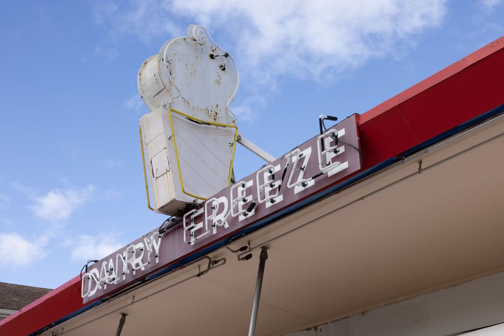 Neon Dairy Freeze sign with white ice cream cone cut out