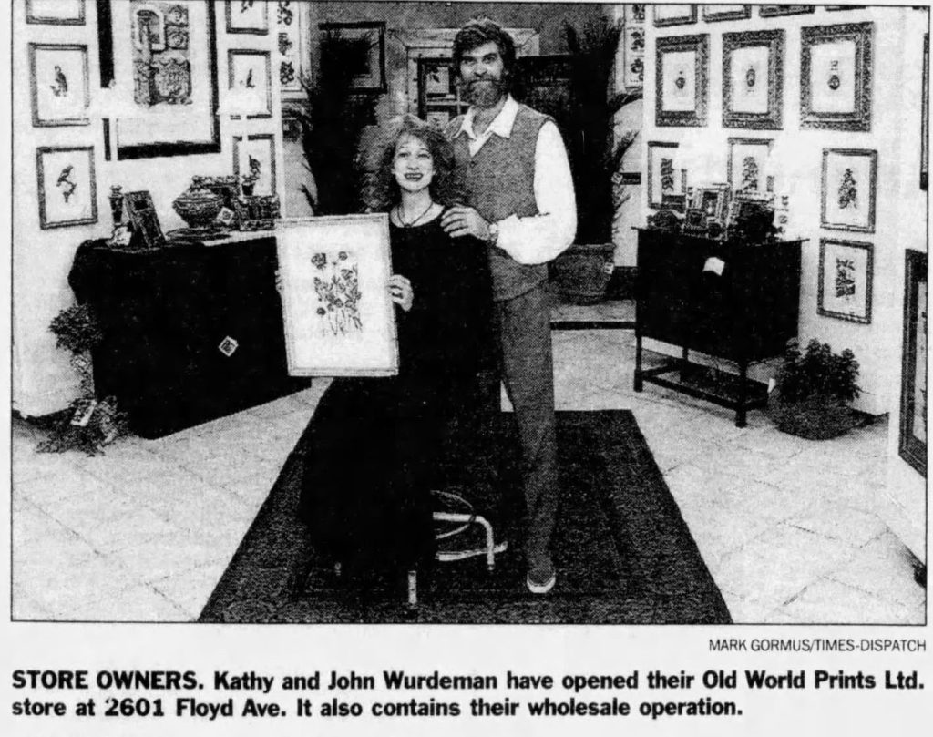 Black and white image of man and woman holding artwork