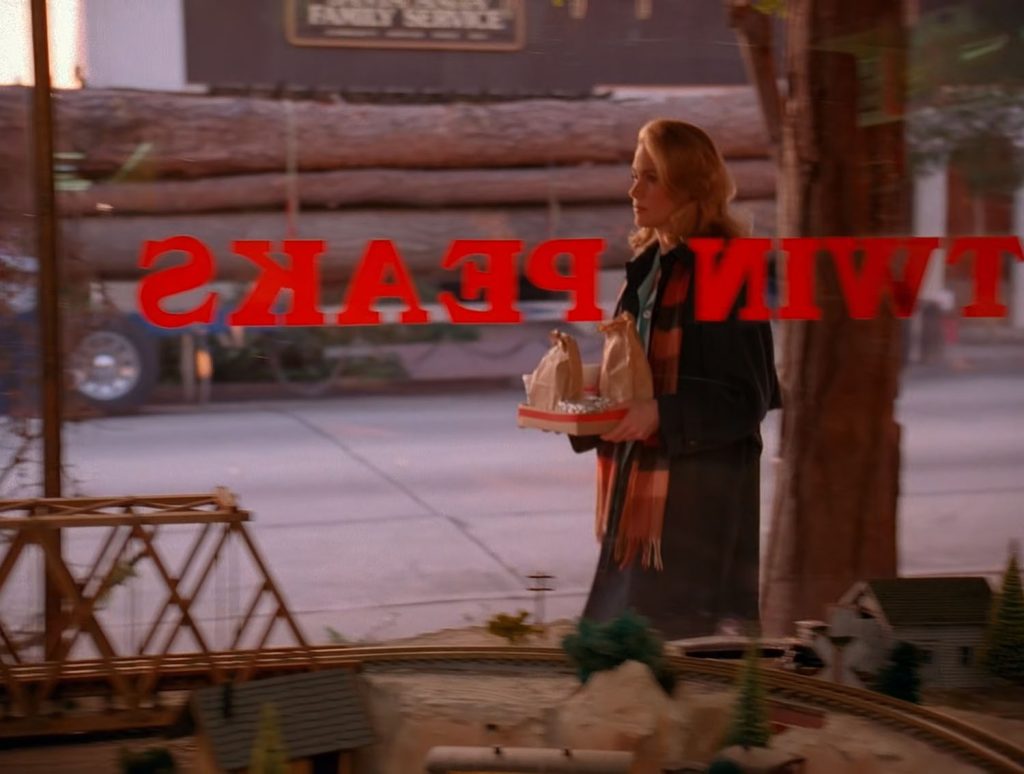 Norma Jennings walking in front of the Twin Peaks General Store Window