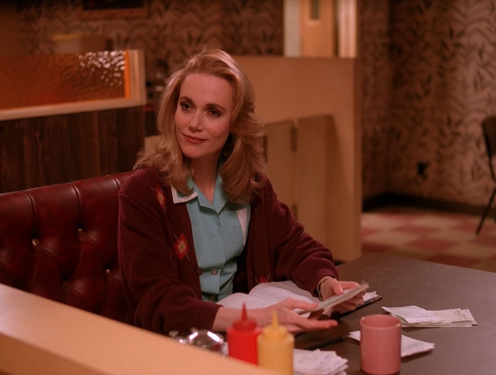 Norma Jennings sitting at a booth in the Double R Diner