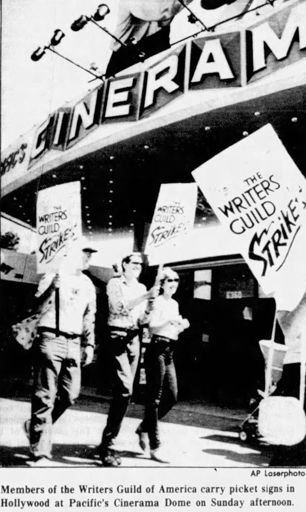 Black and white image of picketers outside the Cinerama in Hollywood, California