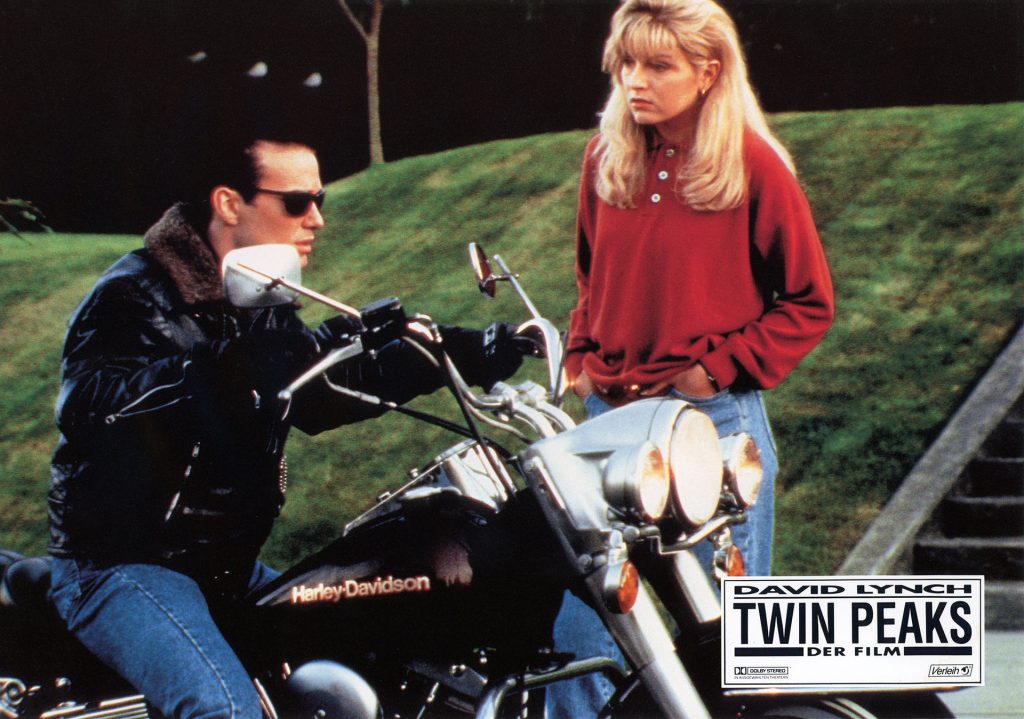 Twin Peaks: Fire Walk With Me Lobby Card from Germany featuring James Hurley sitting on a motorcycle with Laura Palmer standing nearby