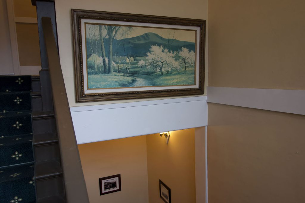 Painting hanging above a stairwell in an apartment building