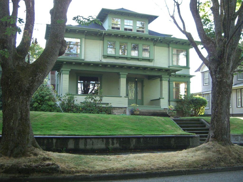 Exterior of green home on a hill