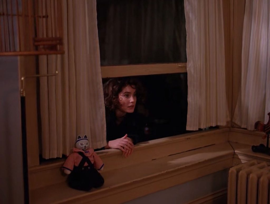 Donna Hayward climbing out the window