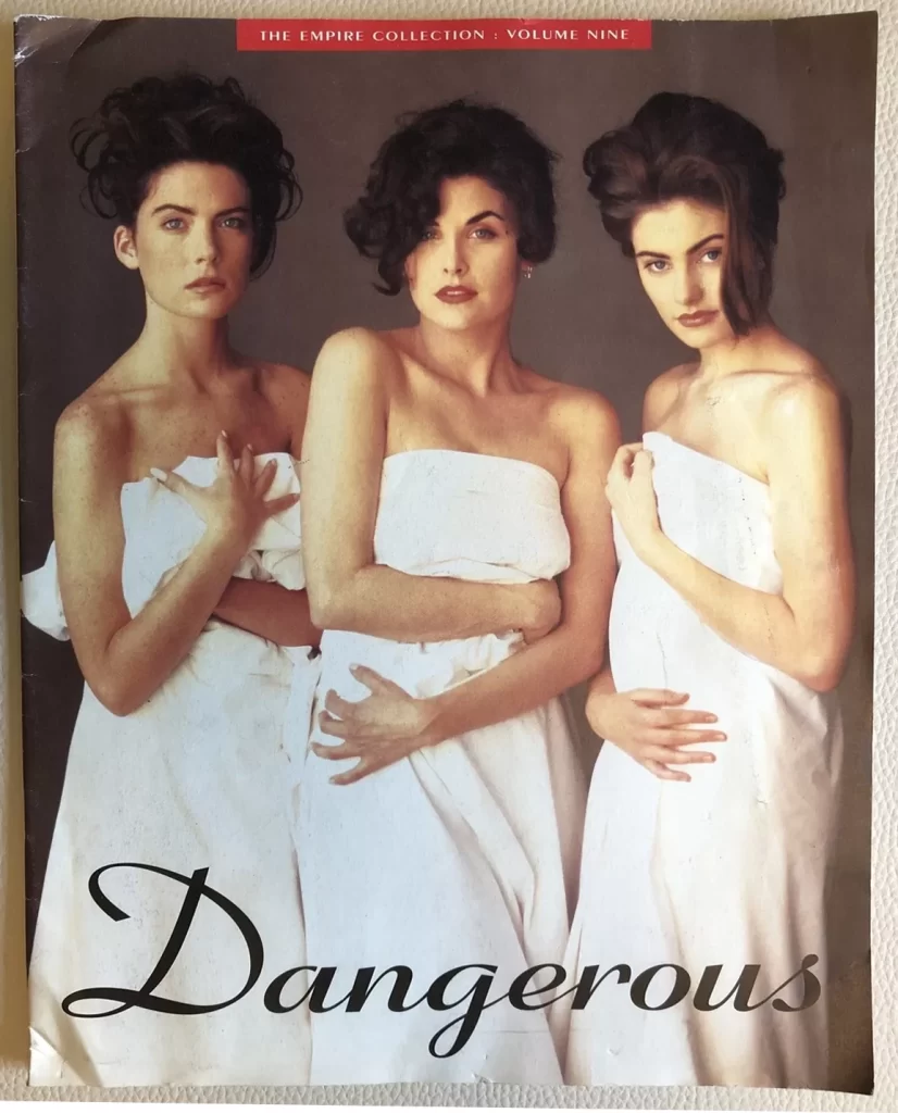 Three women wearing white sheets wrapped around their bodies