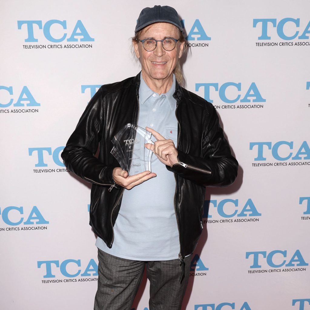 Mark Frost holding a glass award