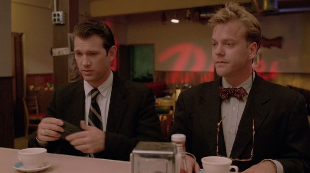 Agents Chet Desmond and Sam Stanley sitting at a counter