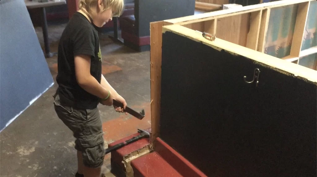 Young boy disassembling a counter