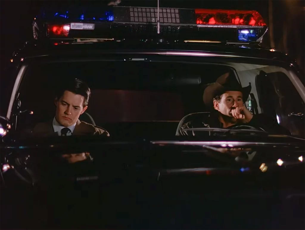 Agent Cooper and Sheriff Truman sitting in a Ford Bronco