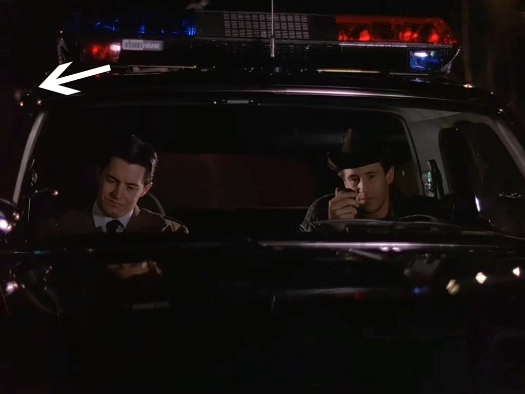 Cooper and Truman in the Sheriff's cruiser