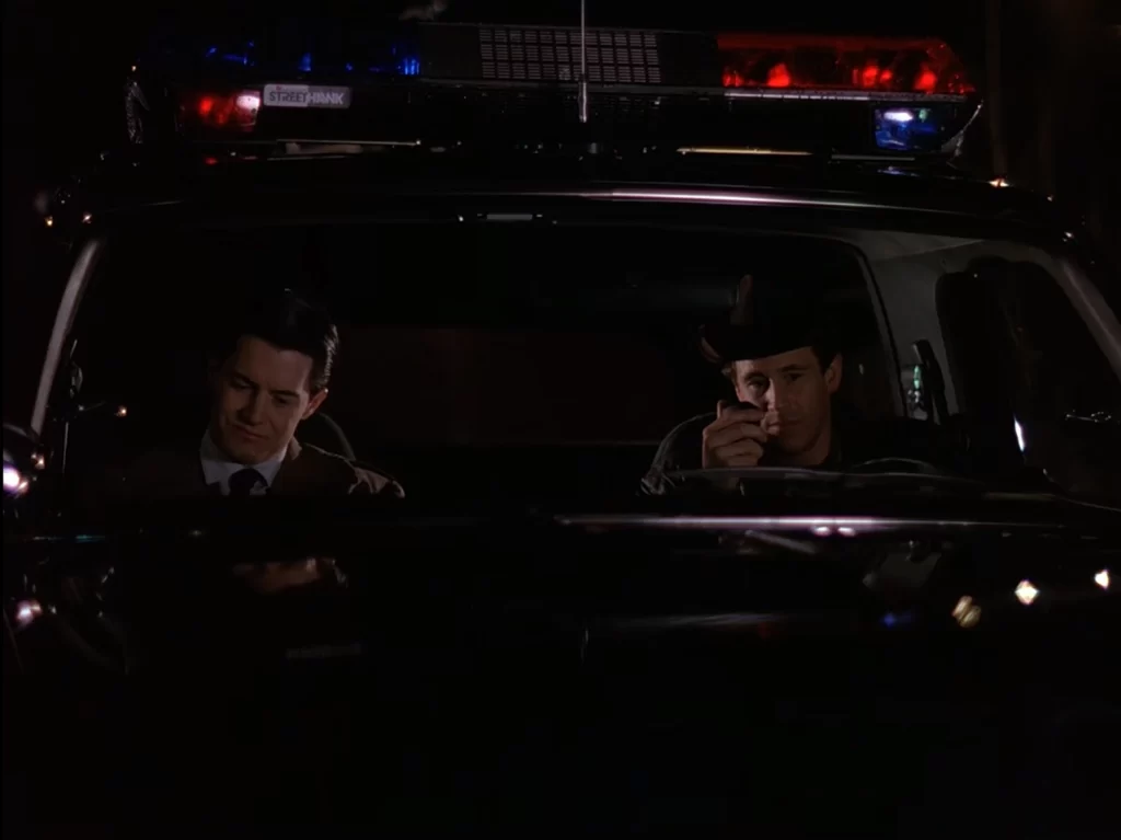 Cooper and Truman in the Sheriff's cruiser