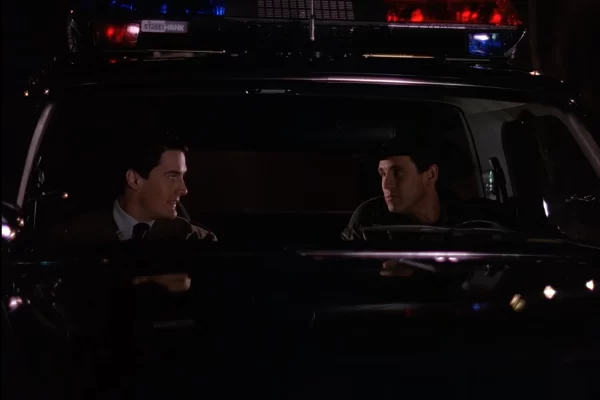 Cooper and Truman in the Sheriff's cruiser