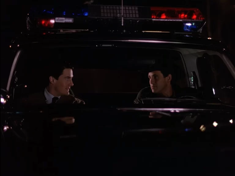 Cooper and Truman in the Sheriff's cruiser