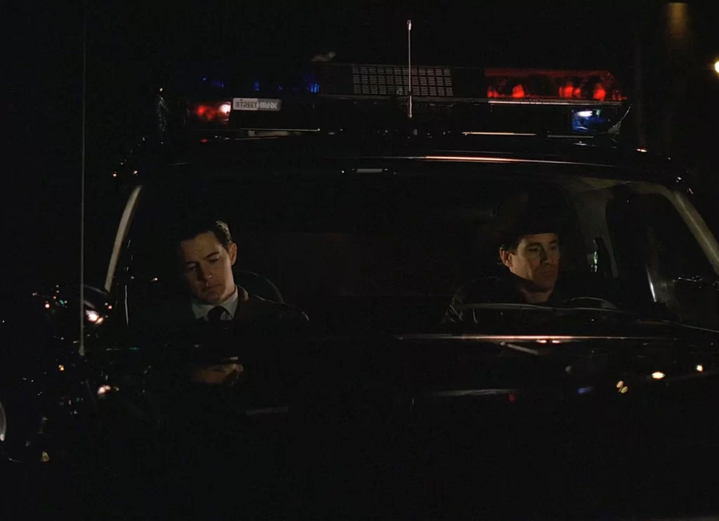 Cooper and Truman in the Sheriff's cruiser