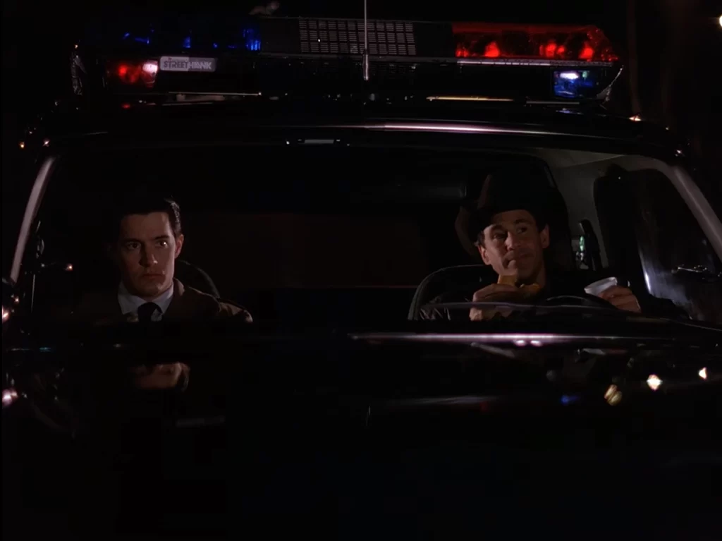 Cooper and Truman in the Sheriff's cruiser