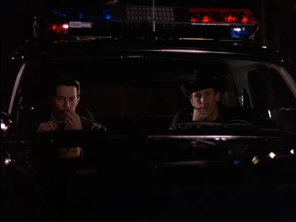 Cooper and Truman in the Sheriff's cruiser