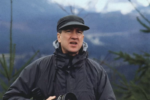 David Lynch holding a camera lens