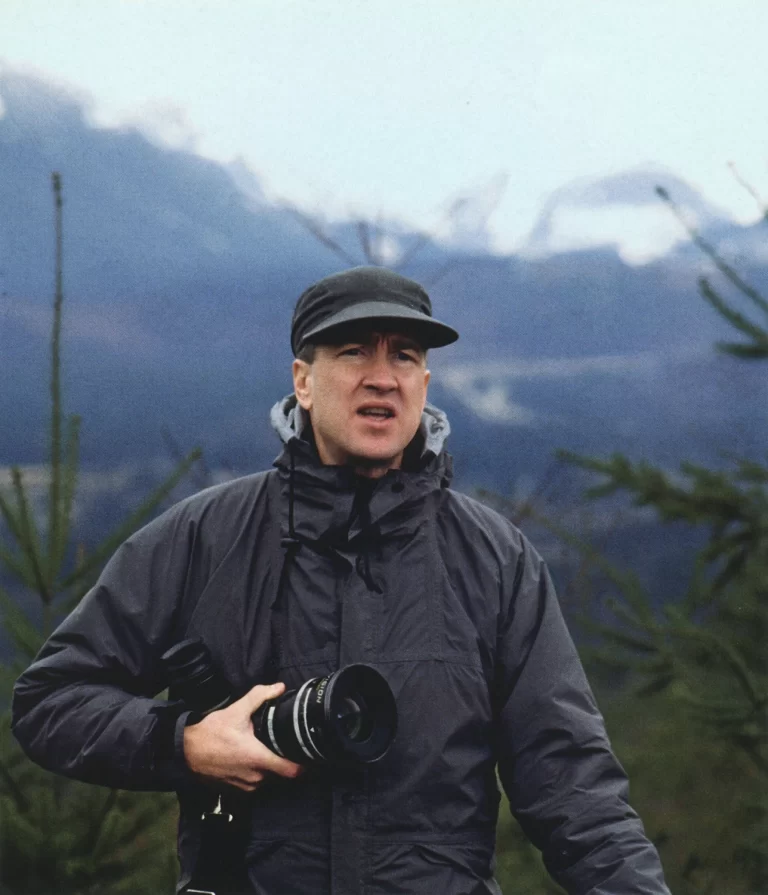 David Lynch holding a camera lens