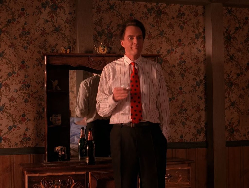 Ben Horne standing by a vanity holding a wine glass