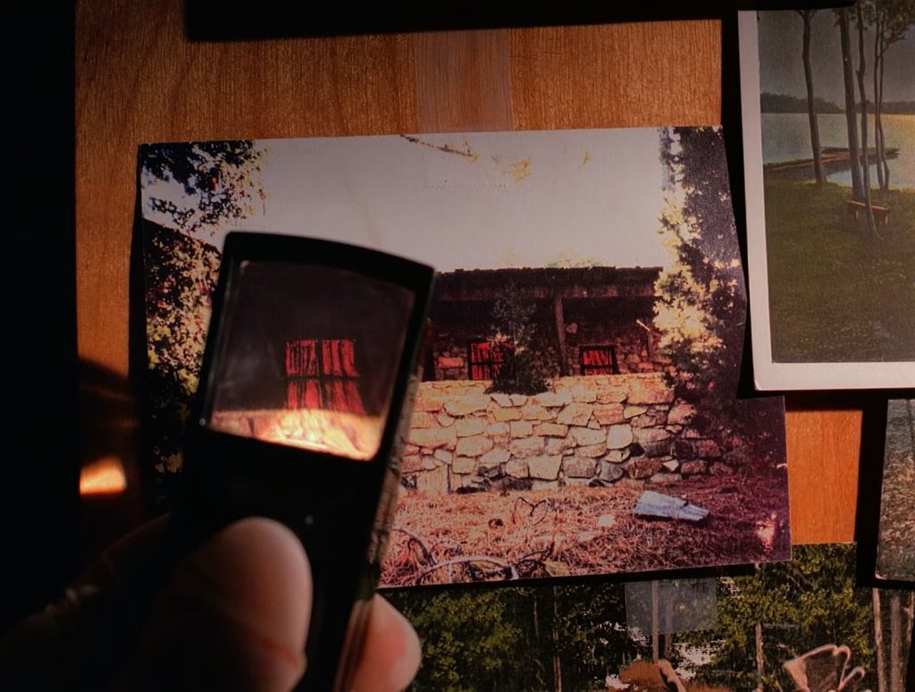 Magnify glass looking at red drapes in cabin window