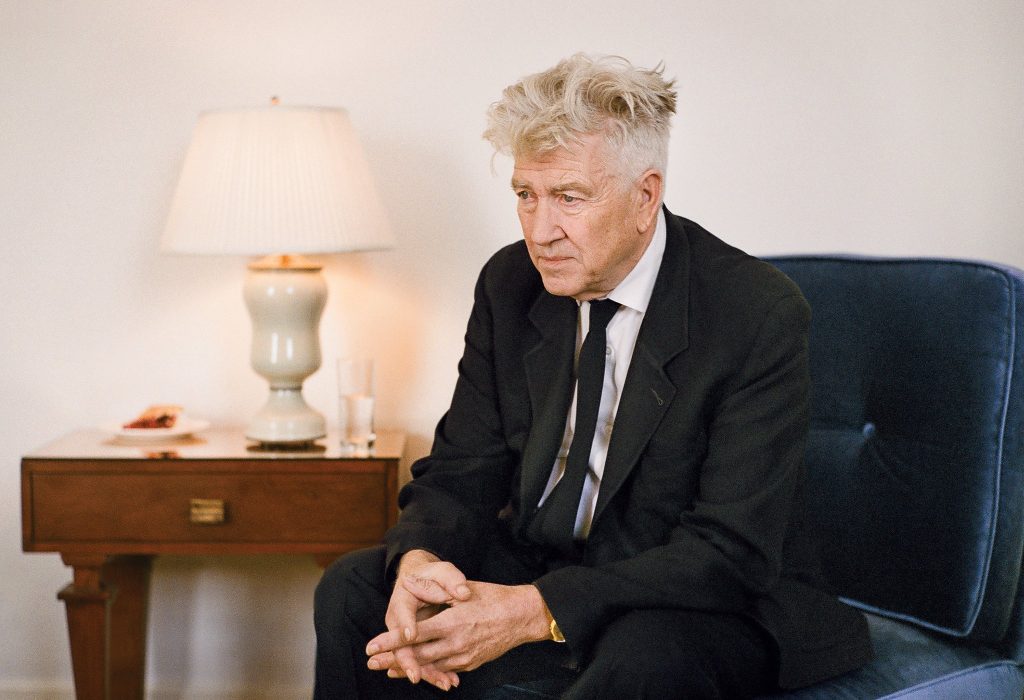 David Lynch sitting in a chair