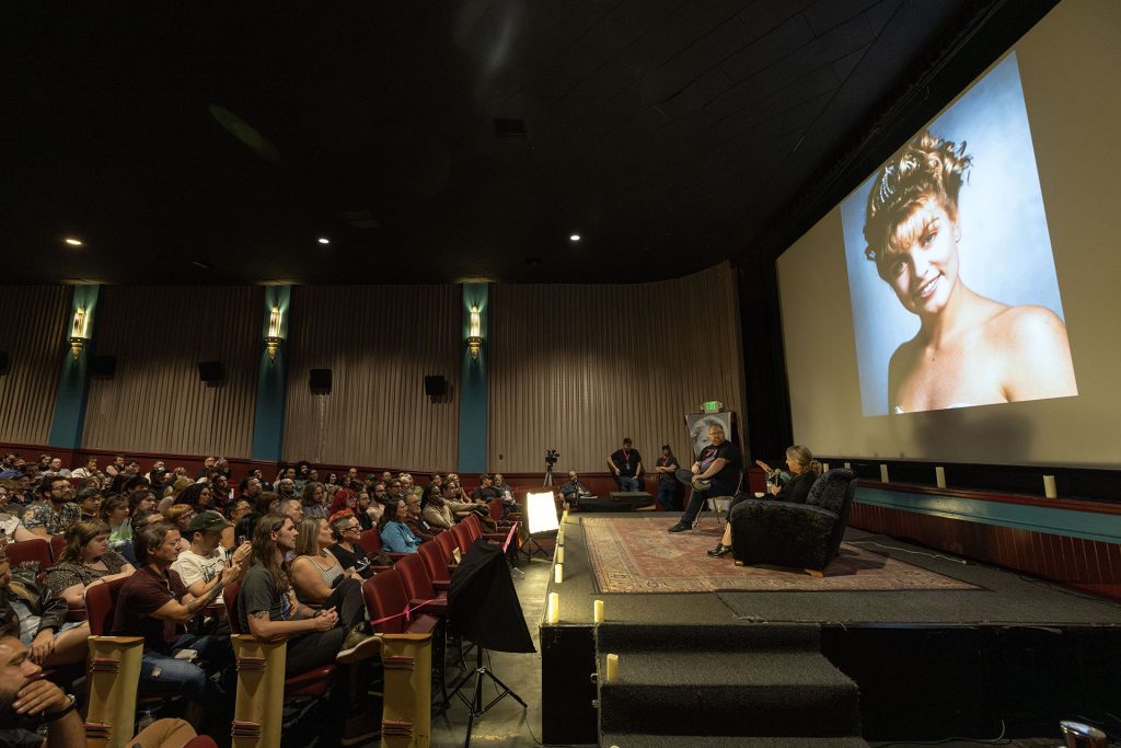 Sheryl Lee on stage with Mike McGraner and audience in theatre